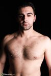 Cute gay Fabian undresses and poses naked with his stiff cock in