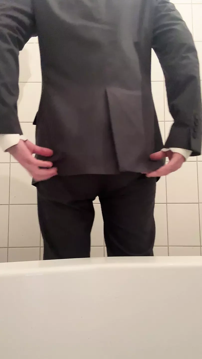 Nappy twink wearing a full nappy under his suit at work