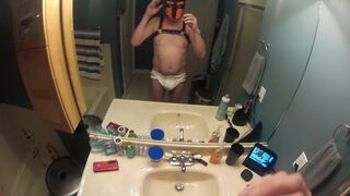 Pup twink in a nappy in the bath tub to play with