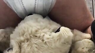 boy poops diaper over teddybear