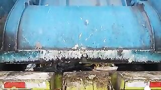 Garbage truck rear loader crushing diapers