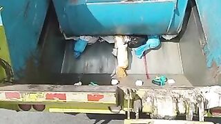 Garbage truck rear loader crushing diapers