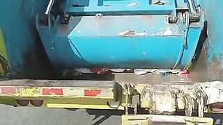Garbage truck rear loader crushing diapers