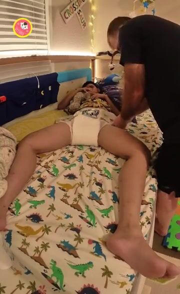 Cute diaper boy getting a change from Daddy