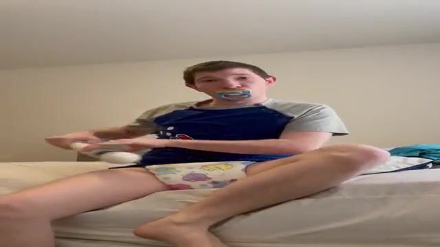 Diaper boy shows off his thick padding, plays with wand