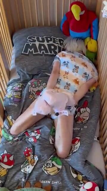 Diaper boy hogtied in crib