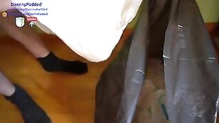 Diaper boy trashing 8 old diapers in garbage bag while wearing wet diaper