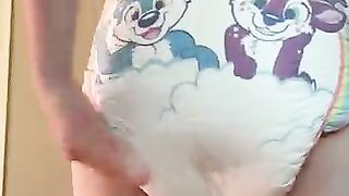Diaper boy pushes mush into thick diaper