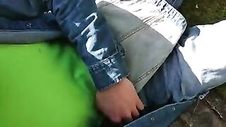 Diaper boy wearing overalls wetting in park