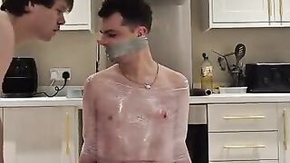 Locked diapered boy tied up and teased