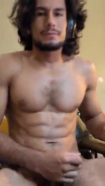 Latino guy stroking his dick
