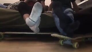gay skaters taking off socks and rubbing feet