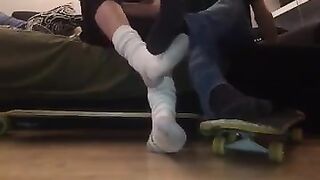 gay skaters taking off socks and rubbing feet
