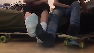 gay skaters taking off socks and rubbing feet