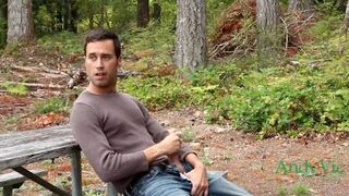 Cumming in a park along a road with traffic