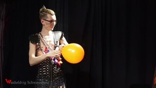 Nicky as a superhero destroys balloons